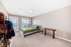 Bedroom with light carpet and access to outside - 