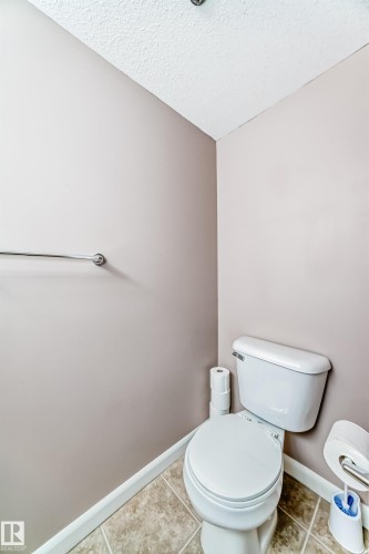 Bathroom featuring a textured ceiling and tile patterned flooring - 232 530 Hooke Road, Edmonton, AB - Indoor Photo Showing Bathroom