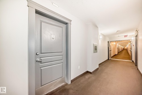 Hallway featuring baseboards and carpet - 232 530 Hooke Road, Edmonton, AB - Indoor Photo Showing Other Room