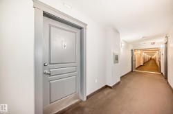 Hallway featuring baseboards and carpet - 