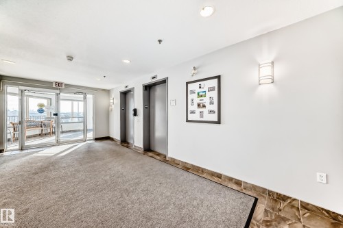 Building lobby with recessed lighting - 232 530 Hooke Road, Edmonton, AB - Indoor Photo Showing Other Room