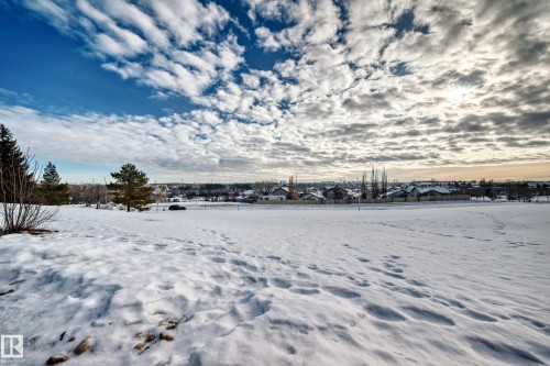 Yard layered in snow with a residential view - 232 530 Hooke Road, Edmonton, AB - Outdoor With View