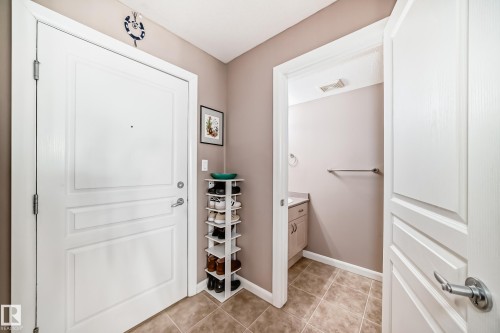Entryway with light tile patterned floors and baseboards - 232 530 Hooke Road, Edmonton, AB - Indoor Photo Showing Other Room