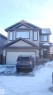 View of front of home featuring stone siding, a garage, and concrete driveway - 31 Newgate Way, St. Albert, AB  - Outdoor 