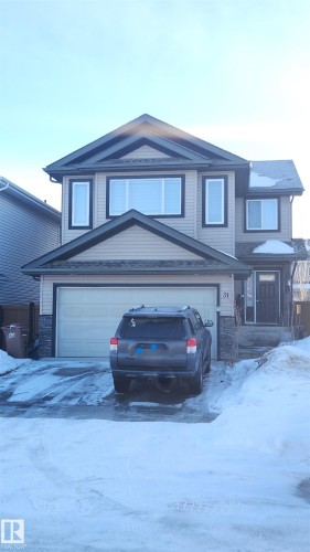 Traditional home with a garage, stone siding, and driveway - 31 Newgate Way, St. Albert, AB - Outdoor