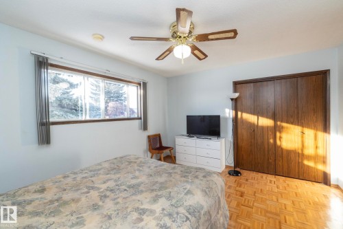 Bedroom with a closet, parquet floors, and a ceiling fan - 9020 152 Avenue, Edmonton, AB - Indoor Photo Showing Bedroom