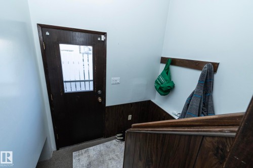 Entryway with carpet and wooden walls - 9020 152 Avenue, Edmonton, AB - Indoor Photo Showing Other Room