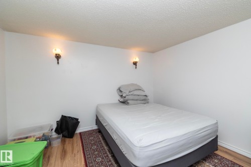 Bedroom featuring a textured ceiling and light wood-style flooring - 9020 152 Avenue, Edmonton, AB - Indoor Photo Showing Bedroom