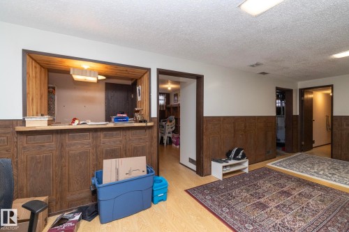Interior space featuring wainscoting, a textured ceiling, and wood walls - 9020 152 Avenue, Edmonton, AB - Indoor Photo Showing Other Room