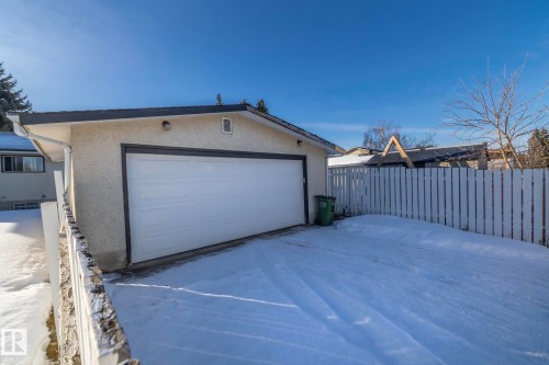 Snow covered garage featuring a detached garage - 9020 152 Avenue, Edmonton, AB - Outdoor