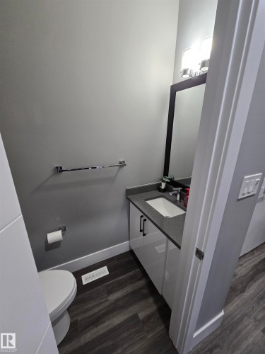 Half bath with vanity and dark wood-type flooring - 1641 Enright Way Nw, Edmonton, AB - Indoor Photo Showing Bathroom