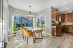Dining area featuring a chandelier, recessed lighting, and light wood finished floors - 