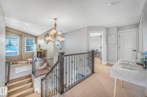 Hallway featuring light colored carpet, a chandelier, an upstairs landing, recessed lighting, and vaulted ceiling - 2307 Rutherford Way, Edmonton, AB - Indoor Photo Showing Other Room