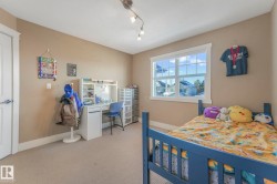 Carpeted bedroom with baseboards and track lighting - 