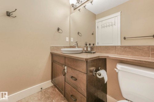 Half bath featuring vanity and light tile patterned flooring - 2307 Rutherford Way, Edmonton, AB - Indoor Photo Showing Bathroom