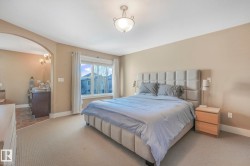 Bedroom with baseboards and arched walkways - 