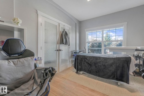 Bedroom with wood finished floors, a closet, and french doors - 2307 Rutherford Way, Edmonton, AB - Indoor