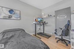 Bedroom featuring light wood-style flooring and baseboards - 