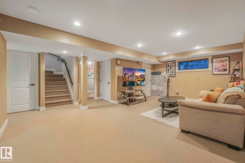 Living area featuring stairs, carpet flooring, and recessed lighting - 2307 Rutherford Way, Edmonton, AB - Indoor Photo Showing Other Room