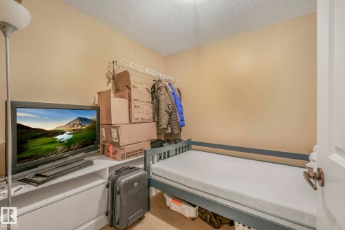 Laundry area featuring a textured ceiling and carpet - 2307 Rutherford Way, Edmonton, AB - Indoor