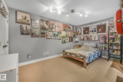 Carpeted bedroom with baseboards and a textured ceiling - 