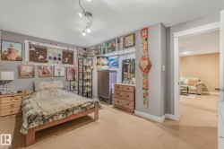 Bedroom with a textured ceiling and carpet floors - 