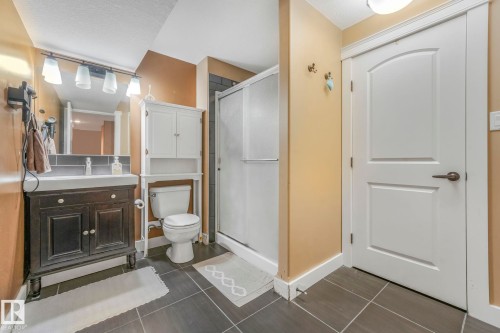 Bathroom featuring vanity, a shower stall, and dark tile patterned floors - 2307 Rutherford Way, Edmonton, AB - Indoor Photo Showing Bathroom