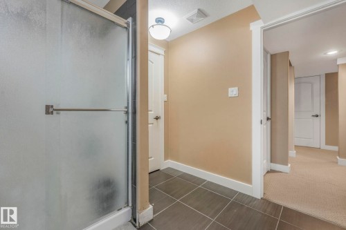 Bathroom with a stall shower and tile patterned floors - 2307 Rutherford Way, Edmonton, AB - Indoor