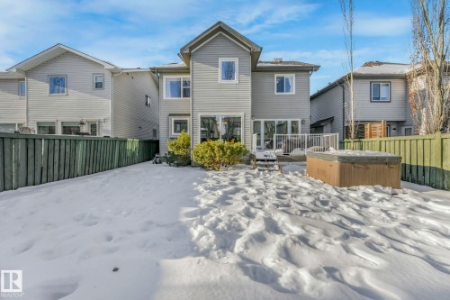 Snow covered property featuring a fenced backyard and a hot tub - 2307 Rutherford Way, Edmonton, AB - Outdoor