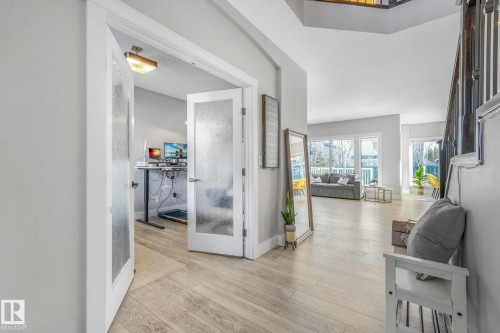 Corridor with light wood-style floors and french doors - 2307 Rutherford Way, Edmonton, AB - Indoor Photo Showing Other Room
