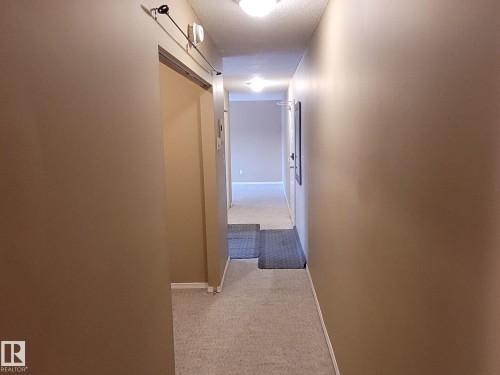 Hallway with light colored carpet and a textured ceiling - 304A 2908 116A Avenue, Edmonton, AB - Indoor Photo Showing Other Room