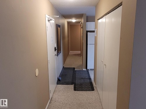 Hallway with a textured ceiling and baseboards - 304A 2908 116A Avenue, Edmonton, AB - Indoor Photo Showing Other Room