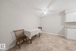 Dining area featuring a ceiling fan and a textured ceiling - 