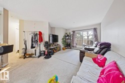 Living area with carpet and a textured ceiling - 
