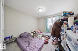 Bedroom featuring carpet floors and a textured ceiling - 