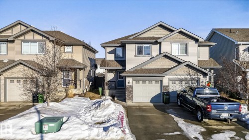 Craftsman house with concrete driveway, a shingled roof, stone siding, and a garage - 2338 Casselman Crescent, Edmonton, AB - Outdoor With Facade