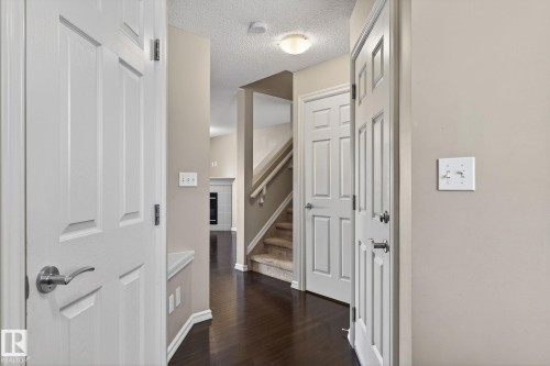 Corridor featuring dark wood-type flooring and a textured ceiling - 2338 Casselman Crescent, Edmonton, AB - Indoor Photo Showing Other Room