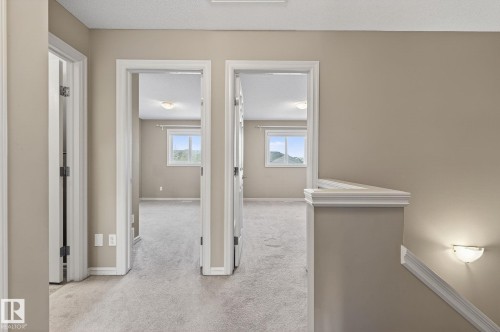 Hall featuring light colored carpet and a textured ceiling - 2338 Casselman Crescent, Edmonton, AB - Indoor Photo Showing Other Room