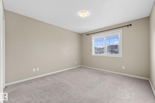 Unfurnished room with light carpet and a textured ceiling - 2338 Casselman Crescent, Edmonton, AB - Indoor Photo Showing Other Room