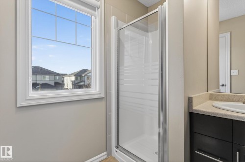 Full bathroom featuring a stall shower, vanity, and a textured ceiling - 2338 Casselman Crescent, Edmonton, AB - Indoor Photo Showing Bathroom