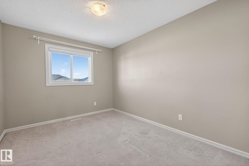 Unfurnished room featuring carpet flooring and a textured ceiling - 2338 Casselman Crescent, Edmonton, AB - Indoor Photo Showing Other Room