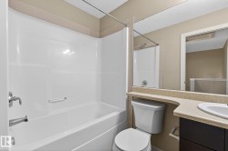 Full bathroom with vanity, tub / shower combination, and a textured ceiling - 