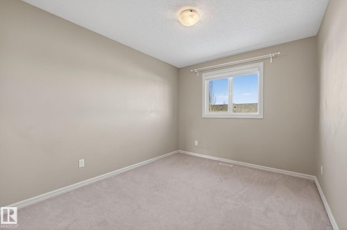 Carpeted spare room featuring baseboards and a textured ceiling - 2338 Casselman Crescent, Edmonton, AB - Indoor Photo Showing Other Room