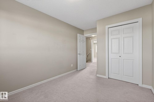Unfurnished bedroom with carpet flooring, a closet, and a textured ceiling - 2338 Casselman Crescent, Edmonton, AB - Indoor