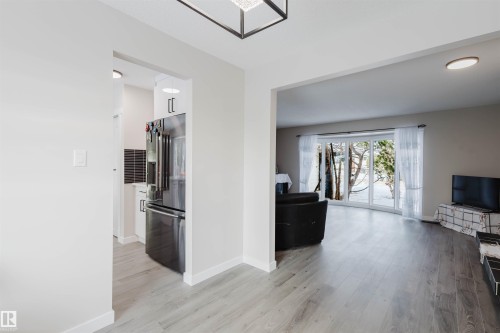 Hallway with light wood-style floors and baseboards - 10423 35 Avenue, Edmonton, AB - Indoor Photo Showing Living Room