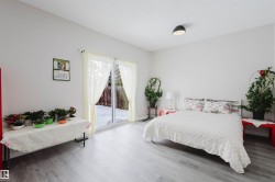 Bedroom featuring access to outside and wood finished floors - 