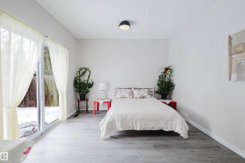 Bedroom with access to exterior and wood finished floors - 10423 35 Avenue, Edmonton, AB - Indoor Photo Showing Bedroom