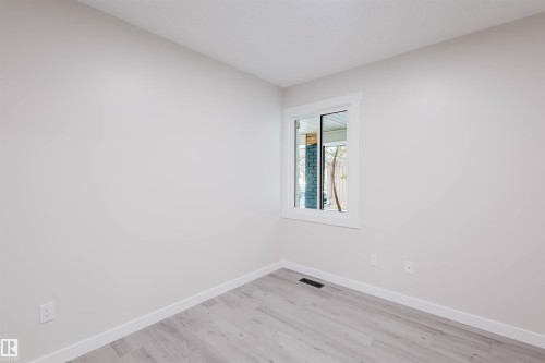 Spare room featuring baseboards and light wood-style floors - 10423 35 Avenue, Edmonton, AB - Indoor Photo Showing Other Room