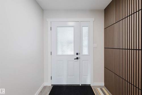 Entryway featuring baseboards and wood finished floors - 10423 35 Avenue, Edmonton, AB - Indoor Photo Showing Other Room