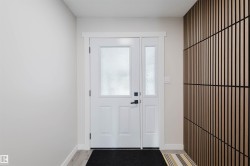 Entryway featuring baseboards and wood finished floors - 